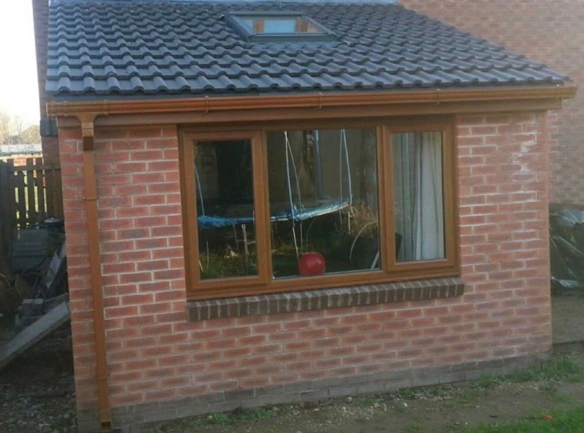 Brick extension with tiled roof and new window