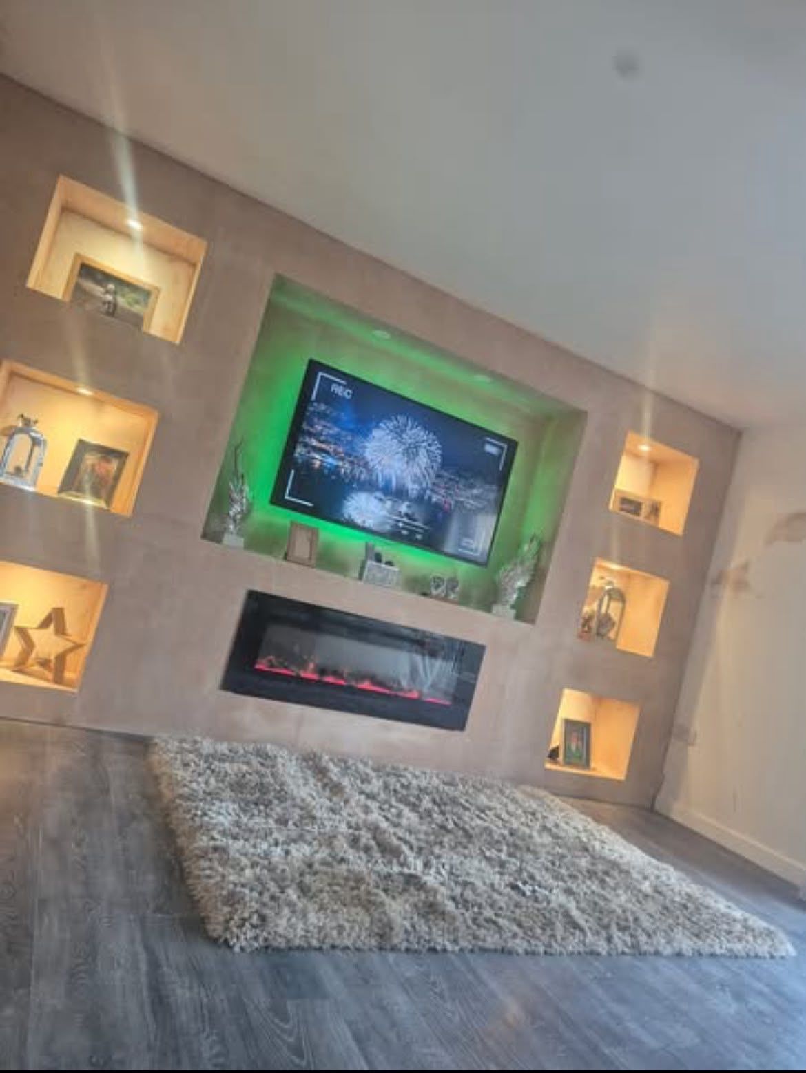 Media wall with LED lighting and display shelves
